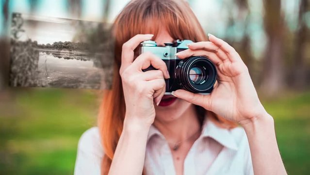 Girl taking photos with old film camera with hologram. Technology concept.