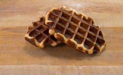Two belgian waffles lying on the desk