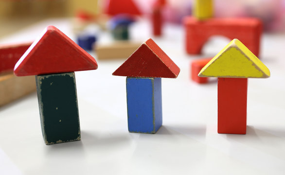 many wooden toys and pieces of buildings in the kindergarten cla