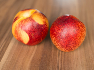 couple of nectarines on wooden background