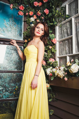 portrait of beautiful elegant young woman in gorgeous yellow evening dress
