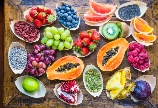 Fototapeta Fresh assorted berries, fruits top view background. Healthy, detox, superfood.