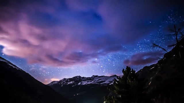 Night motionlapse of clouds and stars above mountains. This is made in 4k resolution.