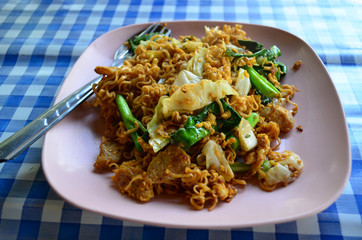 Fried instant noodle with pork and vegetable, selective focus on