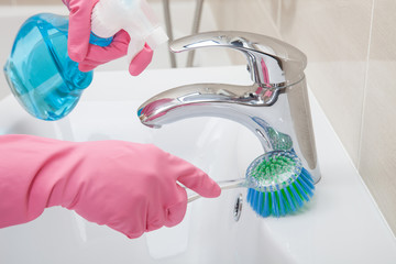 Housemaid cleaning a bathroom