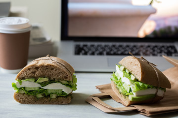 Sandwich with mozzarella, avocado, cucumber, salad and pesto 