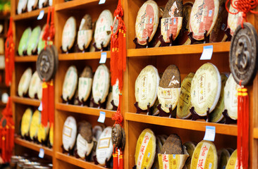 Fototapeta premium Disks of post-fermented tea Yunnan Puer, the Old Town of Lijiang