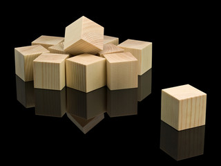 Heap of wooden cubes and separate wooden cube