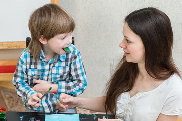 mother with boys son paint colors at home