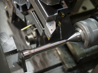 operator machining mold and die part by CNC turning machine in f