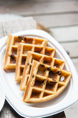Tasty waffles on wood table