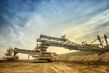 One side of huge mining drill machine connected to transportation facility. Photographed from a...