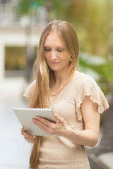 Fototapeta premium woman looking at her tablet