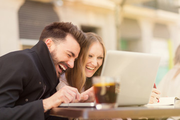 Smiling couple with a laptop