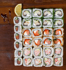Japanese food. Assorted sushi on a wooden table, top view