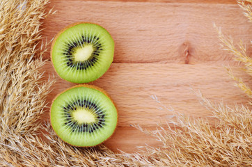 Cut kiwi on a wooden background