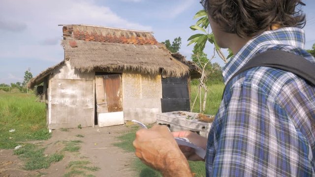 A tourist at a dilapidated rental looks at a hotel reservation and walks away