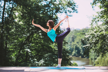Fototapeta na wymiar Woman doing yoga outdoors.