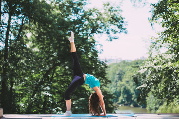 Young Woman doing Yoga Exercises Outdoor