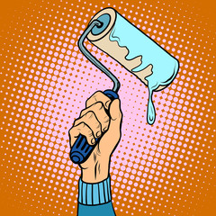 Hand holding paint roller