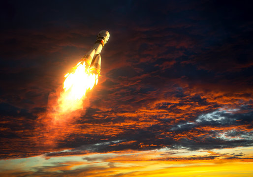 Carrier Rocket Takes Off On A Background Of Red Clouds