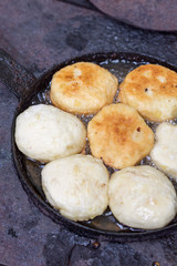 Homemade donuts frying in hot oild on the stove