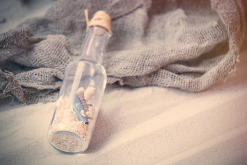  souvenir bottle and fishnet on the sand