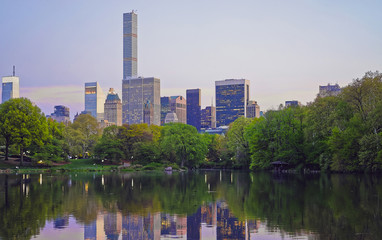 Fototapeta na wymiar Midtown Manhattan skyline reflected from water of Central Park