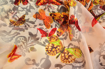 Fototapeta na wymiar Women's scarf with butterflies texture
