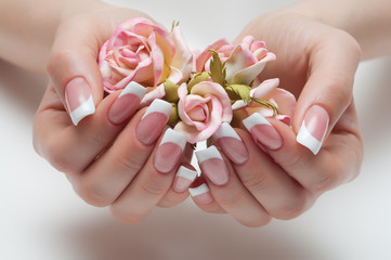 delicate French manicure with a rose in hand