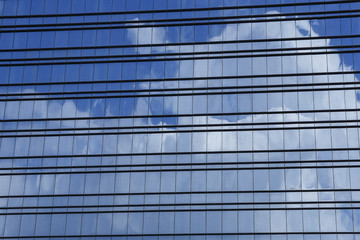 windows of modern building with reflection of clouds