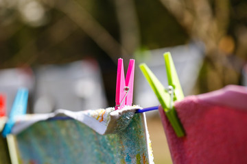 Clothespins holding laundry on the drying line