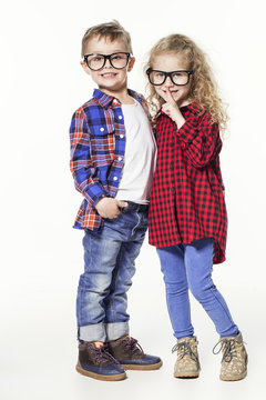 Funny lovely children.  fashionable little boy and girl in glasses, jeans, white t-shirts and plaid shirts. stylish kids in casual clothes in shocked. fashion children