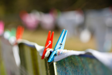 Clothespins holding laundry on the drying line