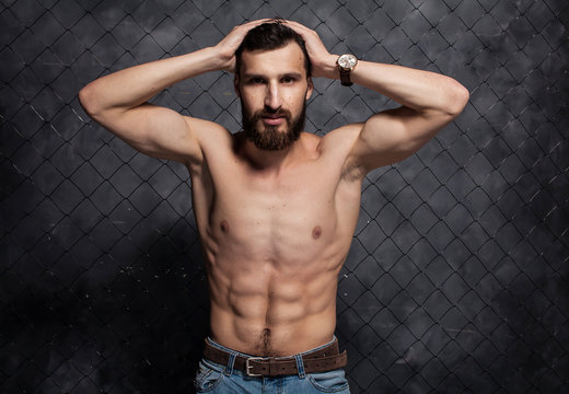 Shirtless muscular sexy bearded guy with beard showing his great body