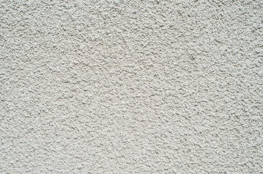 Gray wall closeup uneven granular cement coating