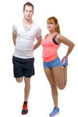 Beautiful young woman and man doing stretching exercises