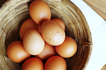 Eggs. Eggs in basket.  Fresh organic raw eggs in wooden basket.