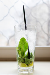 Mahito cocktail with mint on the windowsill