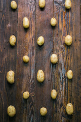 Fresh organic potatoes on a wooden table