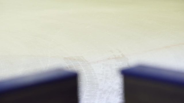 Ice resurfacer cleaning ice at rink