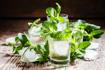 Alcoholic cocktail, mint tea with rum in small glasses with ice