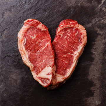 Heart shape Raw fresh meat Steak Striploin on stone slate backgr