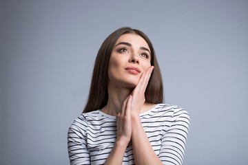 Charming girl standing isolated on grey background 