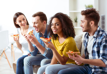 Cheerful friends eating pizza