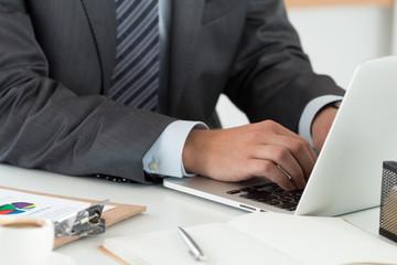 Close-up of businessman hands working on computer
