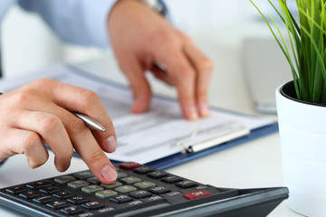 Close up view of bookkeeper hands calculating balance