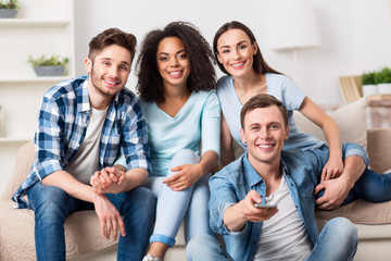 Positive friends sitting on the couch