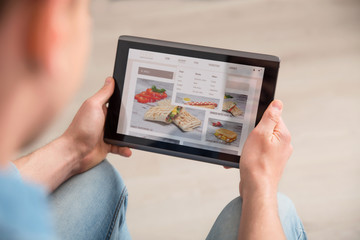 Pleasant guy using tablet