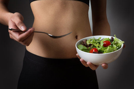 holding a bowl of salad